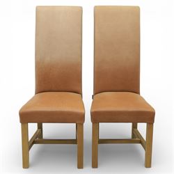 Modern large oak plank top dining table and twelve brown leather high back chairs, table of rustic construction five solid planks with exposed supports, the chairs in brown leather hide with ten standard height and a pair of taller chairs for the foot and head of the table