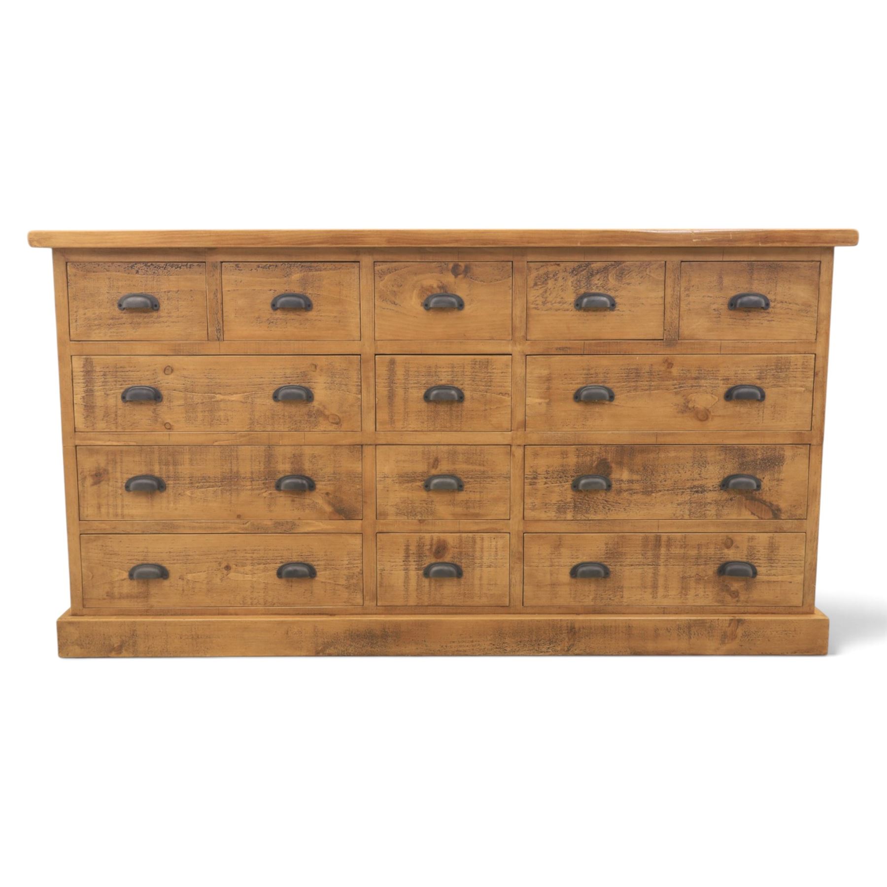 Indigo Furniture - large rustic oak combination chest sideboard, fourteen drawer with blackened metal cup handles, on a plinth base