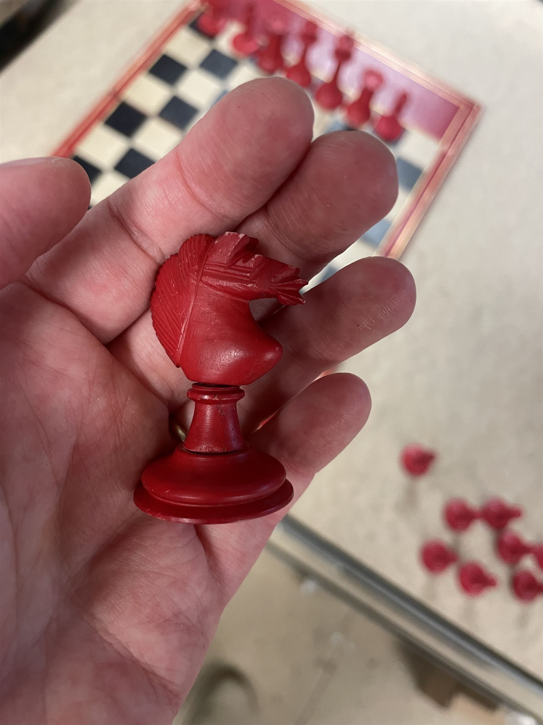 19th century walnut and brass bound games compendium box, painted to enhance the grain, of rectangular form, the hinged opening cover with rounded sides, central brass cartouche with engraved lion crest, and brass riveted straps, opening to reveal a red leather and blue silk lined compartmented interior, with fold-down games board, and lift-out tray containing playing cards, ebony turned dice towers, white and red stained bone draughts, and chess pieces, ivory dice, and ivory and ebony whist markers, and brass bezique board, cribbage board and markers, H15cm W32cm D24cm
This lot has been registered for sale under Section 10 of the APHA Ivory Act