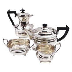 1920s four piece silver tea service, comprising teapot, coffee pot, milk jug and open sucrier, each of bellied form with oblique gadrooned rim and girdle, the teapot and coffee pot with Bakelite style handles and finials, each upon four bun feet, hallmarked Mappin & Webb Ltd, London 1925, coffee pot H22.5cm