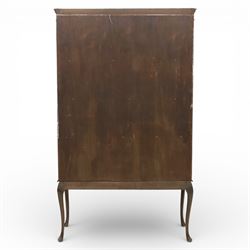 20th century Edwardian style mahogany display bookcase cabinet, the moulded cornice above two lancet glazed doors enclosing a shelved interior, the lower sections with oval inlaid fan decoration, supported on shaped cabriole legs