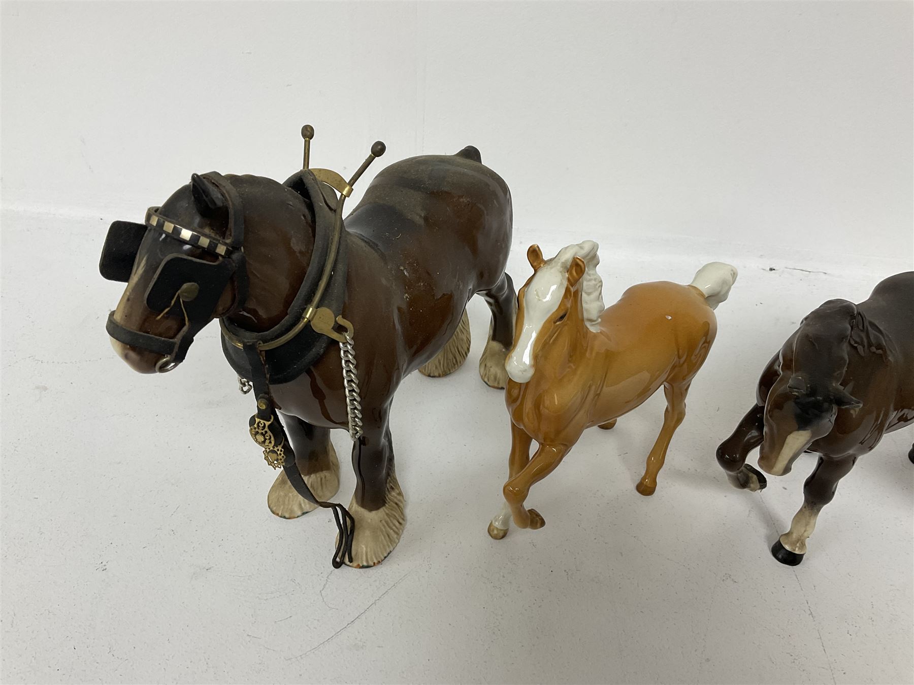 Group of Beswick figures of horses, to include a Palomino horse, Bay Shire horse, recumbent bay foal etc, all with printed marks beneath (5)