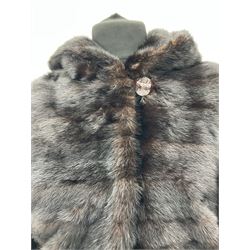 Modern cut lightweight nearly black mink jacket with integral hood, with tie cord to adjust around hips, hinged clip fasteners and loop fasteners, approx size 8  to 14, black satin style lining.  
