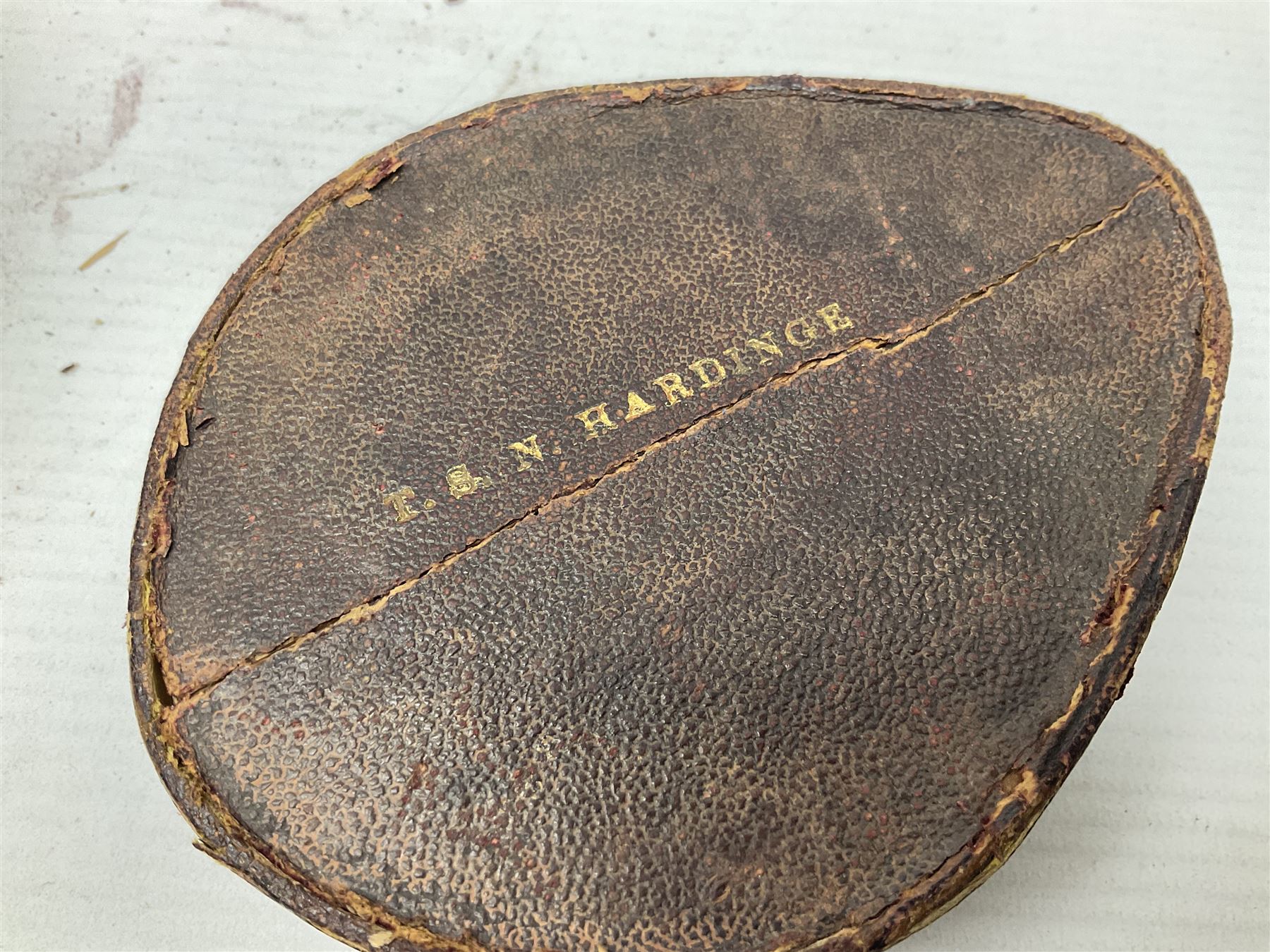 19th century Watkins combined clinometer and compass, patent 217, by J. Hicks Maker 8 Hatton Garden London No.5829, of drum shaped form in lacquered brass case D7cm; both instrument and case bear the name of former owner Thomas S.N. Hardinge; with early 20th century postcard caricature of a serviceman (2)