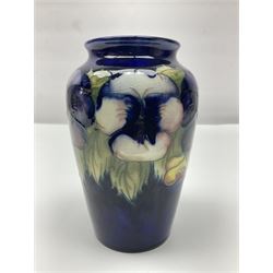 Moorcroft vase, decorated in Pansy pattern upon a dark blue ground, with impressed and painted marks beneath, H16cm