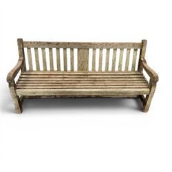 Teak garden bench with slatted back and seat raised on square supports