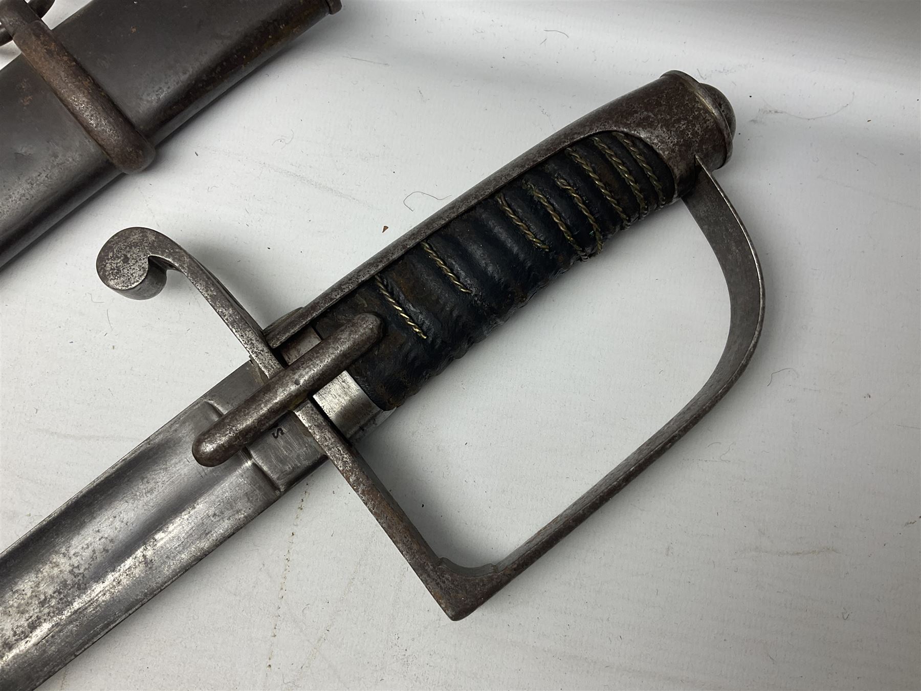 Italian M1833 Sabre with slightly curving 79cm fullered steel blade, the plain steel hilt with 'D' shaped knuckle bow, langets and wire-bound leather grip; in steel scabbard with single hanging ring L101cm overall