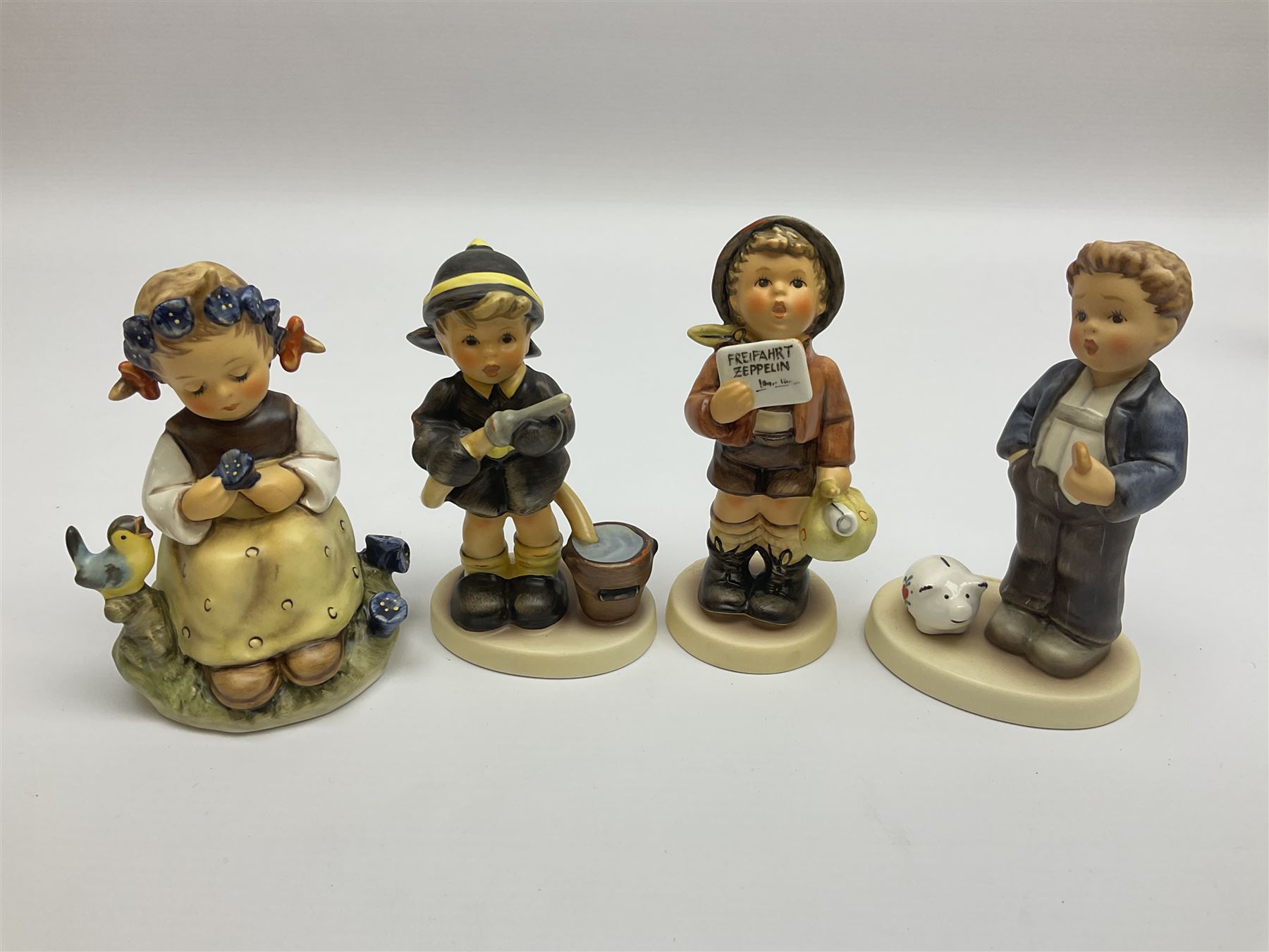 Twenty six Hummel figures by Goebel, to include Fire Fighter, Band Leader and Spring Sowing