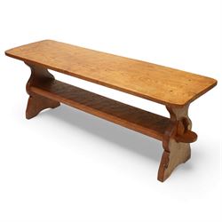 Gnomeman - oak rectangular coffee table, the thick plank top with exposed pegged joints, raised on shaped slab ends united by a lower undertier, carved with the signature gnome to one support, by Thomas Whittaker of Littlebeck