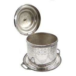Victorian twin handled silver biscuit barrel, hinged lid and circular body with bright cut decoration and crest, raised on three ball feet by John, Edward, Walter & John Barnard (Barnard & Sons Ltd), London 1869 approx 24oz