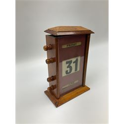 An early 20th century oak perpetual desk calendar, with three glazed apertures for day, date and month, H20cm