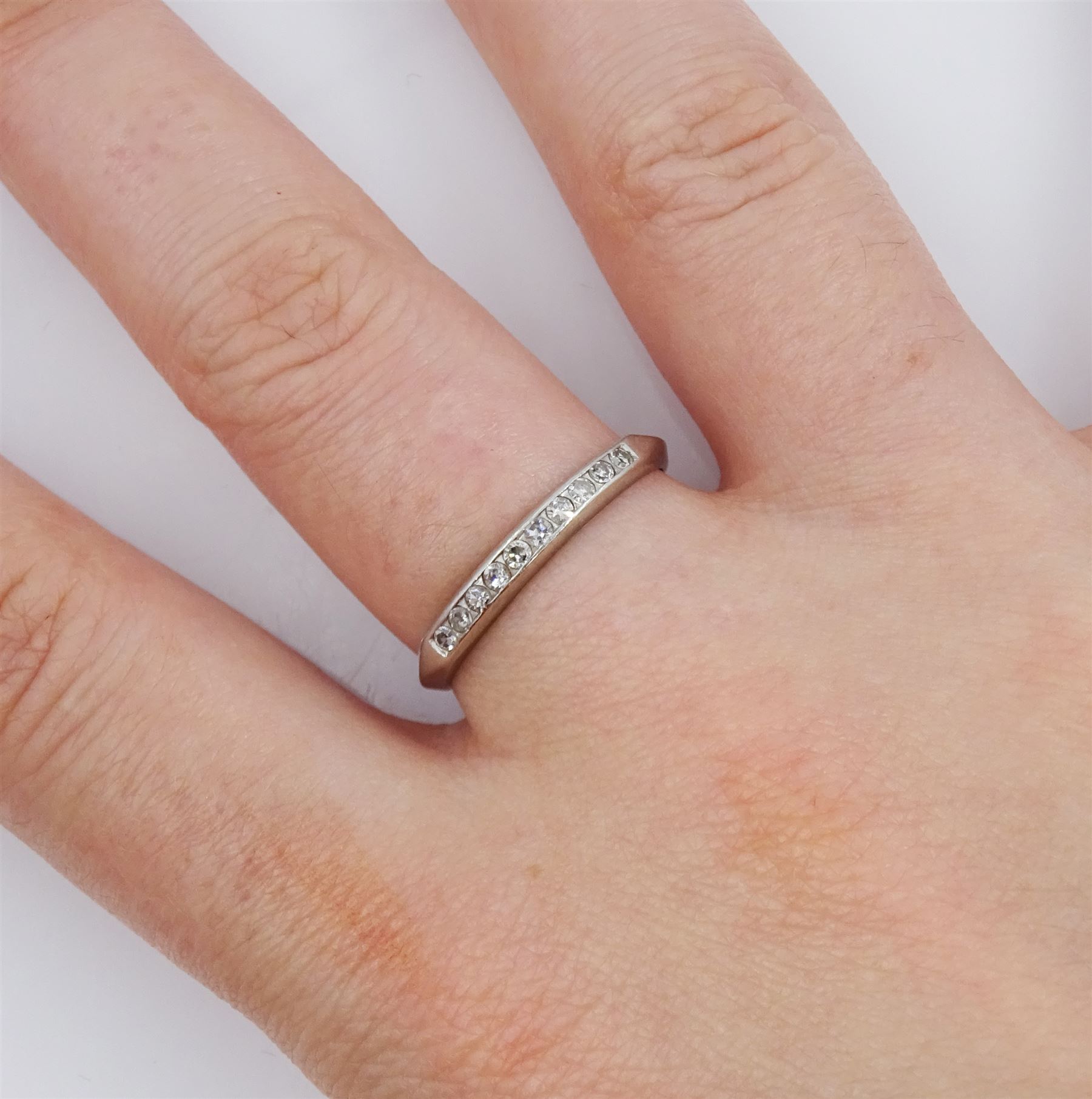 Early 20th century platinum channel set old cut diamond half eternity ring, stamped Plat, boxed