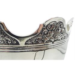 Late Edwardian silver Monteith bowl, the plain body with moulded foliate detailed and shaped rim, upon a circular stepped foot, hallmarked Selfridge & Co Ltd, London 1908, H17cm D21.5cm, approximate weight 31.64 ozt (984.4 grams)
