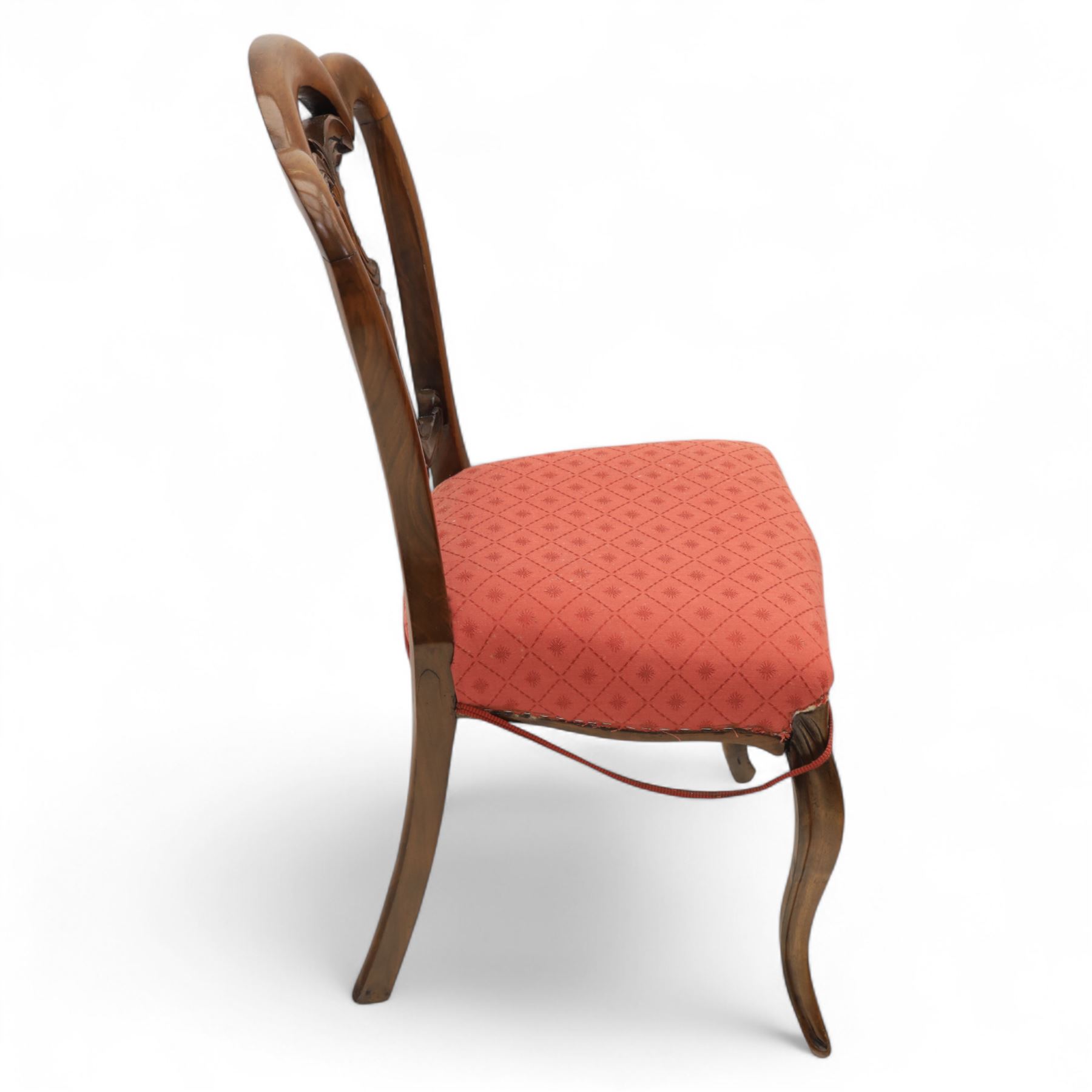 Set of four Victorian walnut balloon back chairs, with a carved and pierced back splat with foliate scrolls, serpentine seat upholstered in a diamond pattern fabric, raised on cabriole legs 