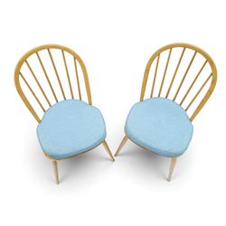 Ercol - pair of 'Windsor' dining chairs, with high hooped back, blue seat cushions with studded, tapered supports  