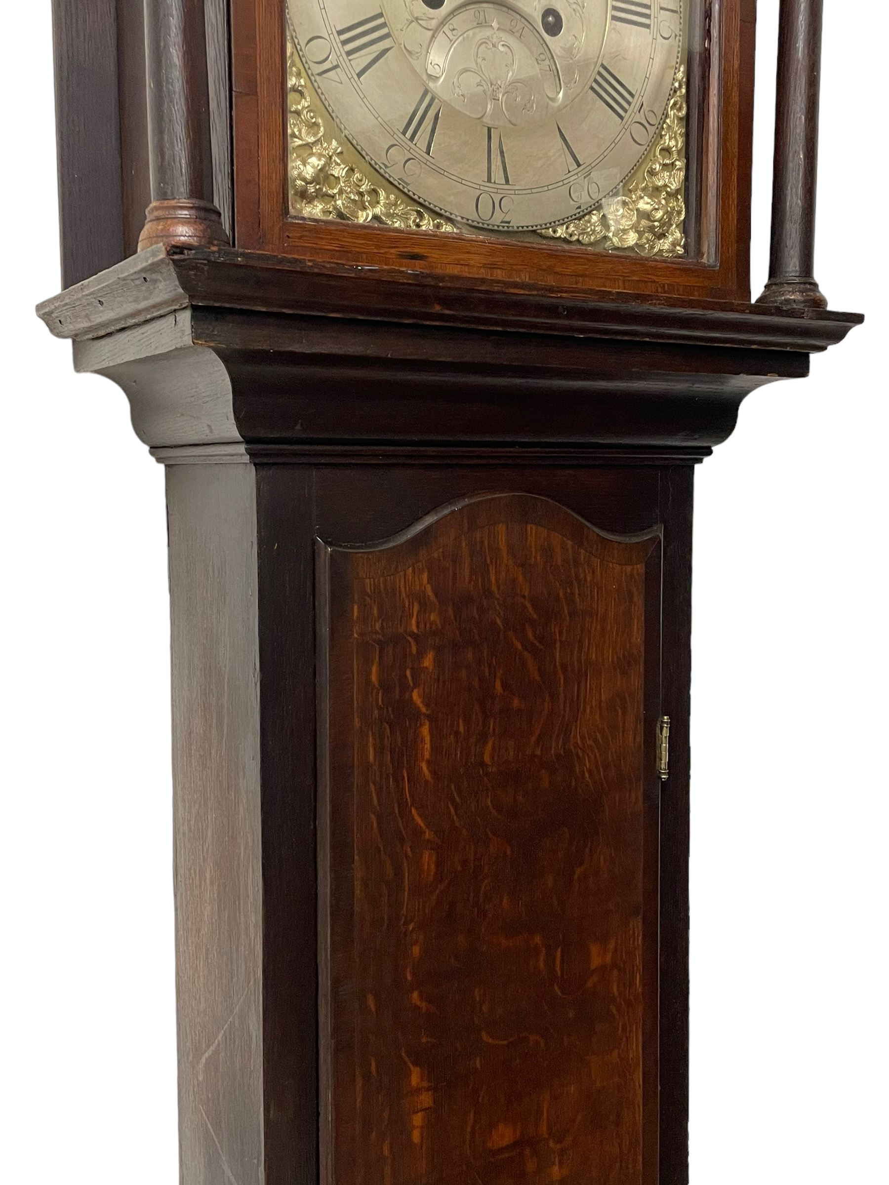 Thomas Hutchinson of Leeds - 18th century 8-day oak longcase clock with as broken arched  pediment and moulded cornice, with a conforming hood door flanked by plain turned pilasters with gesso capitals,  long trunk door with a wavy top on a square plinth with a raised panel, brass dial with cast spandrels,  engraved silvered dial centre and chapter ring with Roman numerals, five minute Arabic's and minute track, with pierced steel hands, seconds pointer,  arched calendar aperture and silvered boss engraved with the makers name to the break arch, dial pinned to a rack striking two train movement with a recoil anchor escapement. With weights and pendulum. Thomas Hutchinson is recorded as working in Leeds from 1760-90.