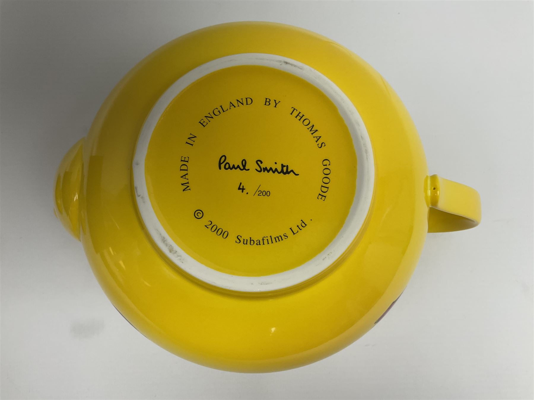 Limited edition Beatles Yellow Submarine teapot, designed by Paul Smith and made for Thomas Goode, 4/200, together with matching egg cups, 25/200, both in original boxes. 