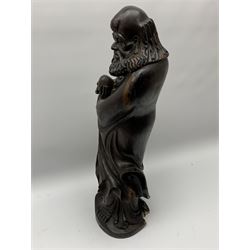 Large 19th century Chinese zitan figure, modelled as one of the eight immortals holding a peach, H60cm