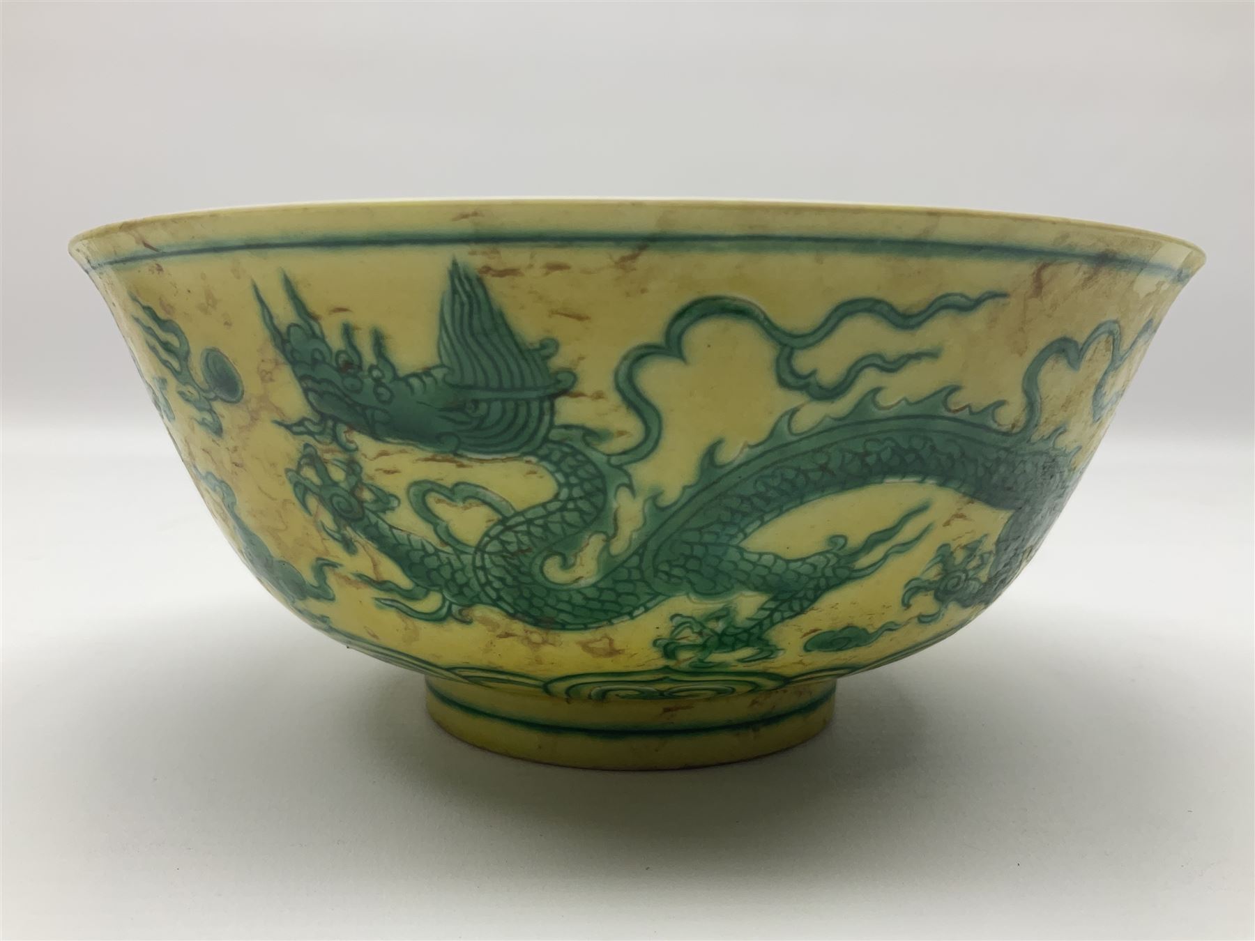 Pair of Chinese famille jaune bowls, decorated in green enamel with a dragon chasing a flaming pearl amongst clouds, upon a yellow ground, the interior decorated to centre with dragon, with six character mark beneath, D17.5cm