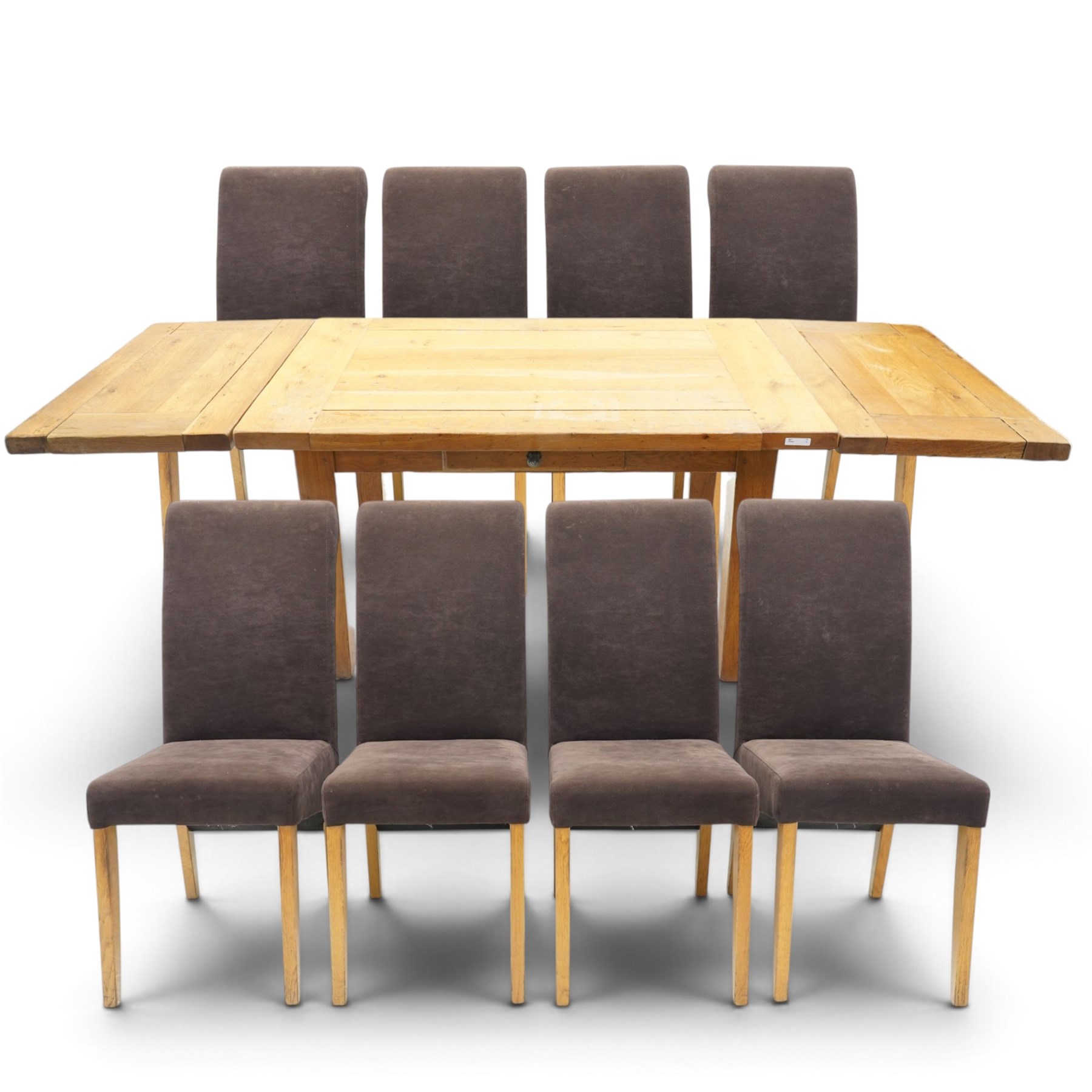 Modern solid oak extending dining table and eight upholstered chairs, the table of plank top construction raised on square supports, extended to 231cm with leaves 