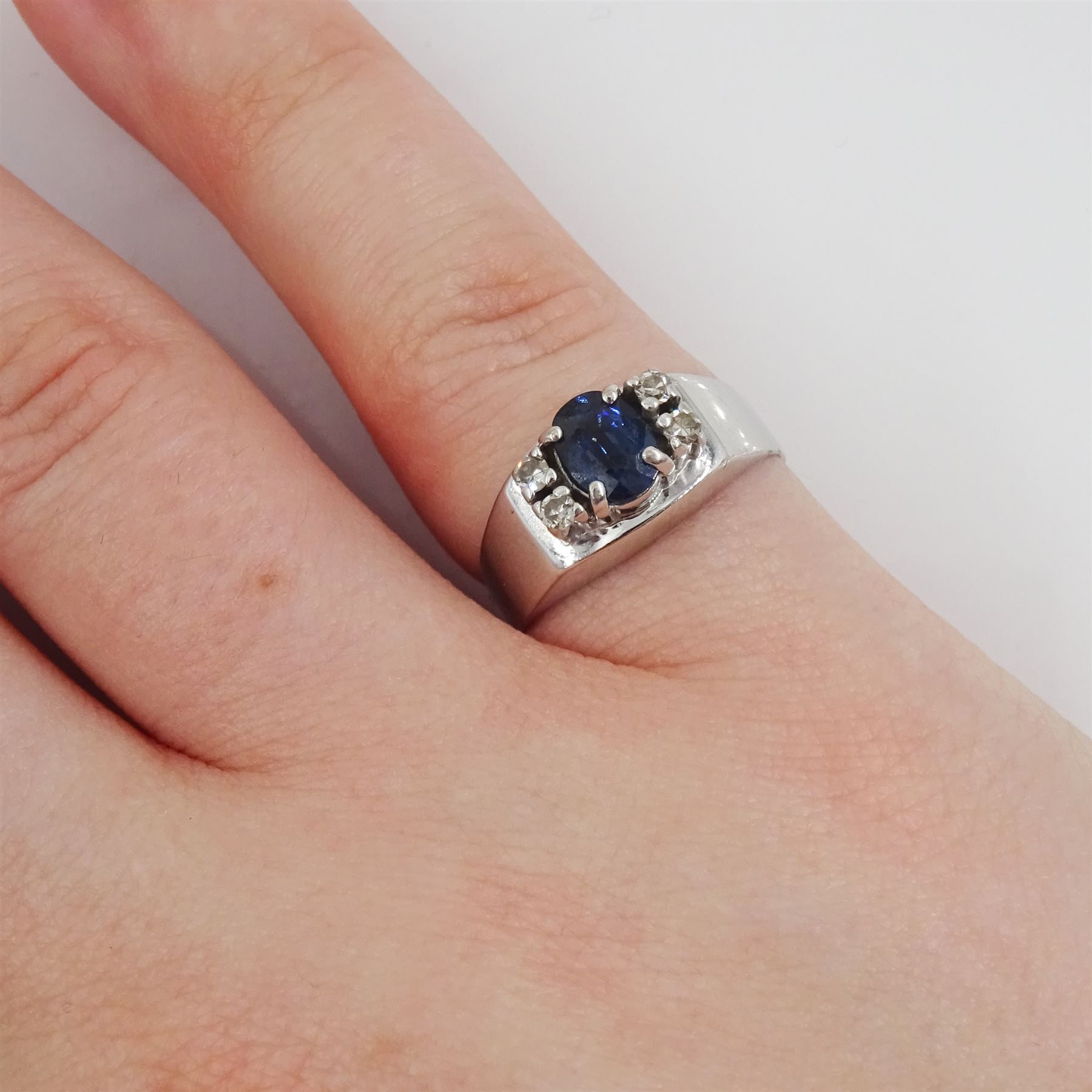 18ct white gold oval cut sapphire and four stone, round brilliant cut diamond ring, hallmarked, sapphire approx 0.60 carat