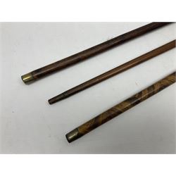Three early 20th century walking sticks, to include a smoking pipe walking stick, the cane opening to reveal a concealed pipe, and a wooden walking cane, the metal cover with inscription 'bell metal and wood of York Minster, Burnt May 20 1840, and a turned wooden walking stick, with marquetry checkerboard pommel, tallest L90cm