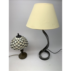 A small Tiffany style table lamp, with leaded glass shade, overall H38cm, together with another table lamp with curved metal base and cream shade, overall H66cm. 