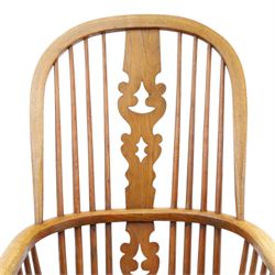 19th century elm Windsor armchair, with central pierced splat, flanked by spindles, dished seat, raised on turned supports united by H-stretcher