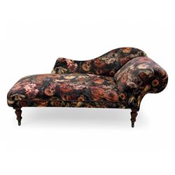 Victorian hardwood-framed chaise longue, serpentine back with rolled arm, upholstered in floral pattern fabric, on ring turned legs with ceramic castors 