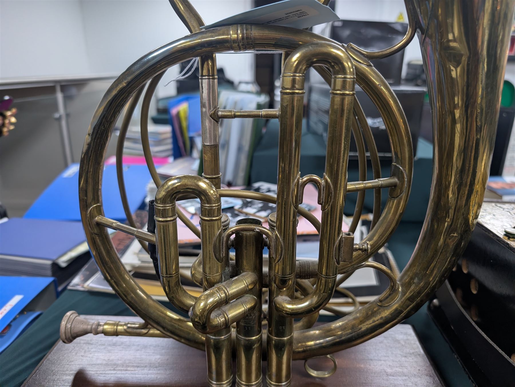 Boosey & Co Ltd French horn, converted into a table lamp, upon a wooden plinth, H45cm
