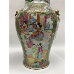 Pair of 19th century Chinese Famille Rose vases and covers, each of baluster form with twin gilt lion mask ring handles to shoulders, the flattened domed covers with gilt temple lion finials, each decorated with alternating reserves of bijin and attendants, and birds and butterflies amongst blossoming peonies, against a gilt ground profusely decorated with stylised scrolls, H32.5cm