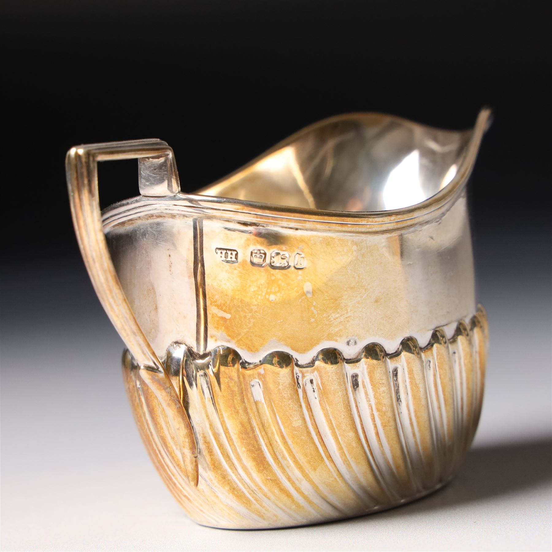Late Victorian bachelors silver tea set of oval form with half body decoration, the teapot with ebonised handle and lift Sheffield 1895 Maker Harrison Bros. & Howson