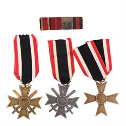 WWII Third Reich three War Merit Crosses, two with swords, together with a four piece meda...