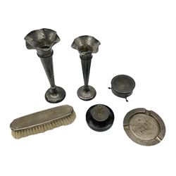 Two early 20th century silver trumpet vases to include a Martin Hall & Co Ltd example, silver circular box raised on three feet stamped Birmingham 1912, ashtray hallmarked London 1945, silver backed hair brush with engine turned decoration etc, tallest H19.5cm