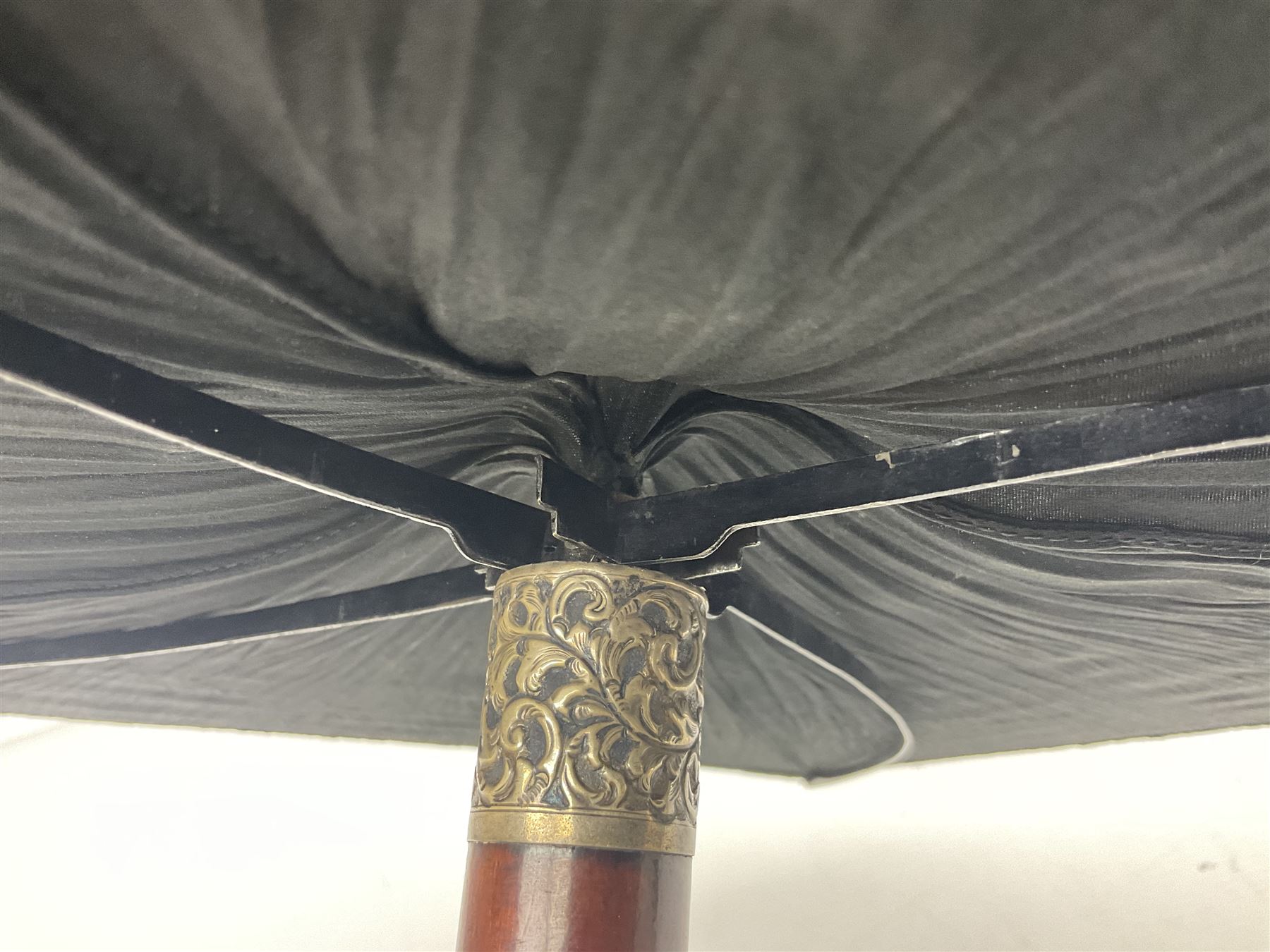 Victorian magician's cane, the mahogany walking stick twisting apart to reveal an internal mechanism, opening to tripod and black silk fold out magician's table, with horn handle and silver mount, hallmarked Birmingham 1891