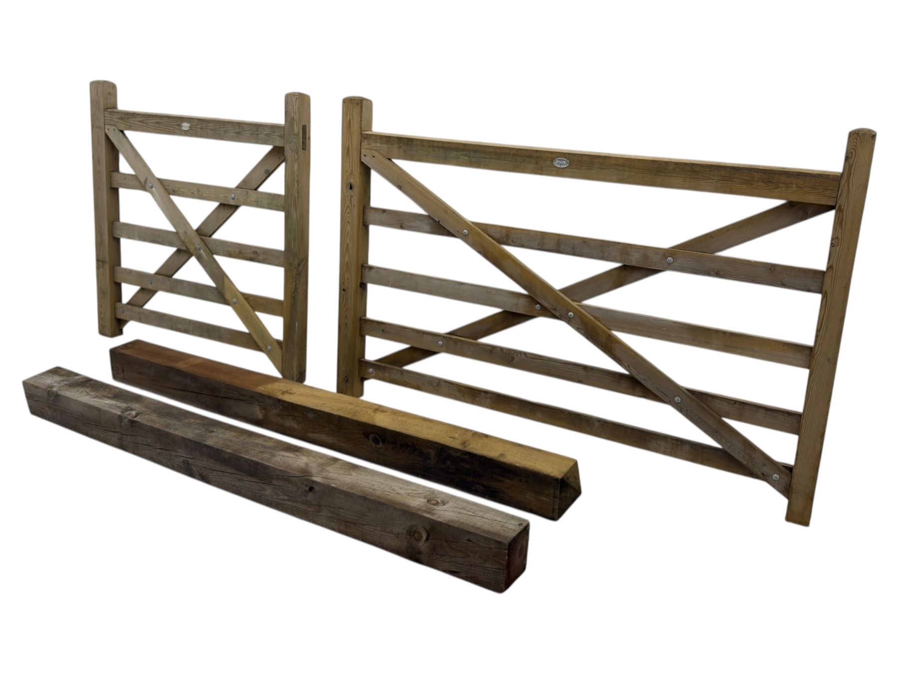 Two wooden gates with post hinges and latches