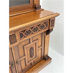 Late Victorian walnut bookcase on cupboard, two glazed cupboards enclosing adjustable shelving, base unit fitted with two carved short drawers and two panelled cupboards, raised on stile supports 