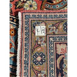 Persian Kashan peach ground rug, central rosette medallion surrounded by trailing branches and flower heads with bird motifs, light blue spandrels with further floral decoration, the main border with repeating palmettes and birds, within guard stripes