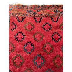 Persian red ground rug, the field decorated with all-over geometric medallions, multi-band border with repeating lozenges 