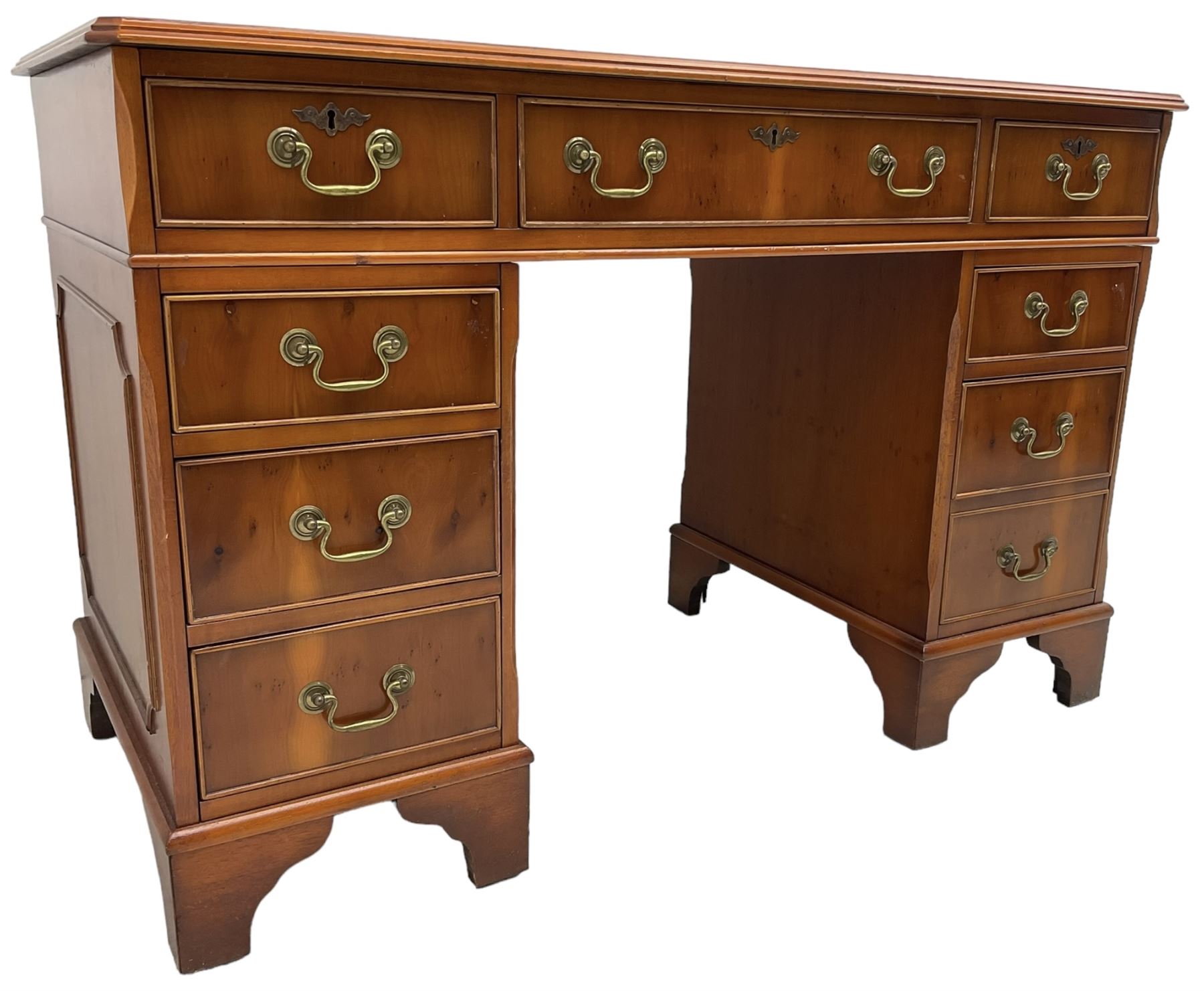 Georgian design yew wood twin pedestal desk, rectangular top with green leather inset writing surface, fitted with nine cock-beaded drawers, on bracket feet