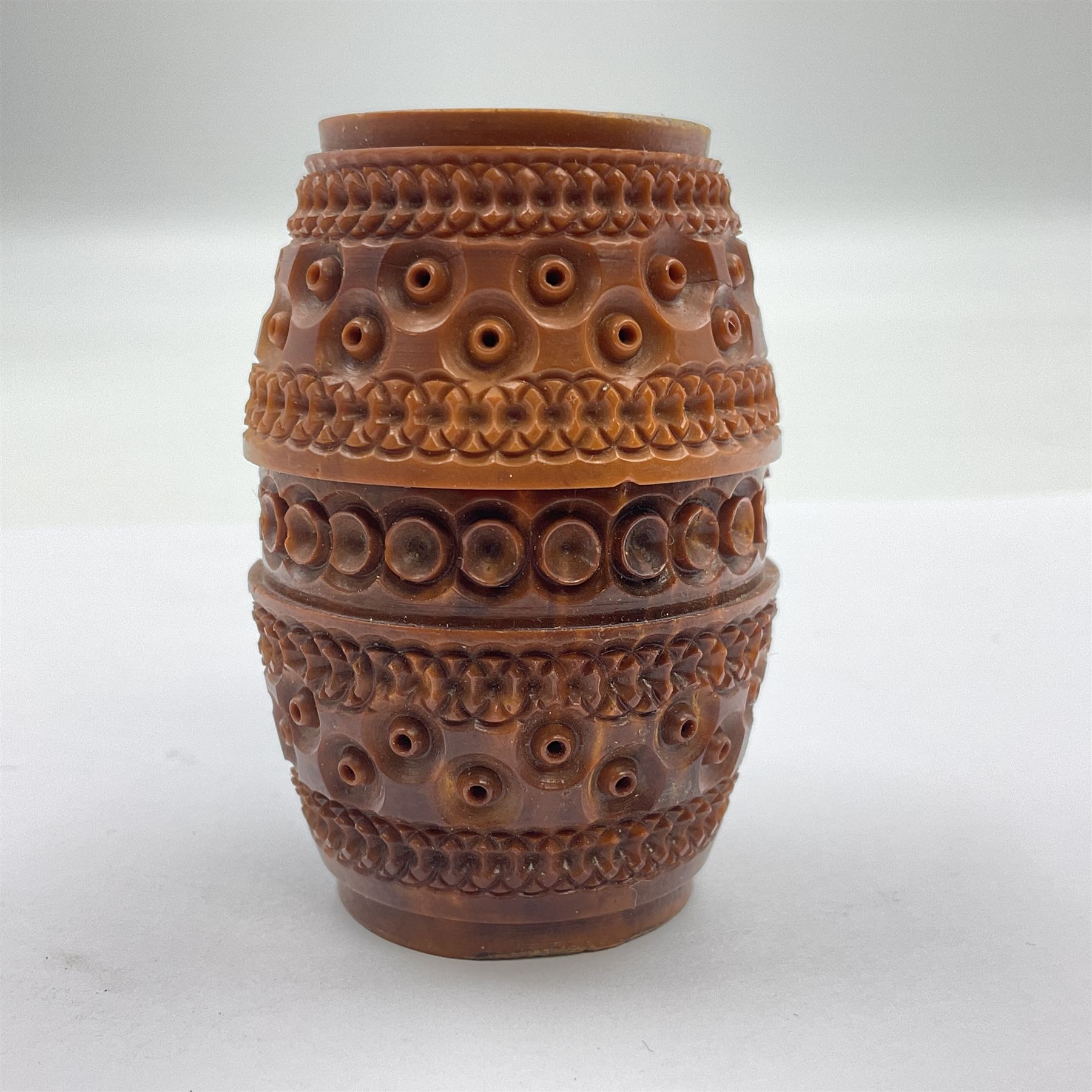 Three 19th century coquilla nut pomanders or flea catchers, two of egg shaped form and the third of barrel from with carved and pierced decoration and screw threaded join, largest H8cm