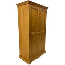 Solid pine double wardrobe, enclosed by two panelled doors