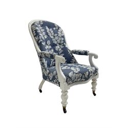 Victorian white painted open armchair, upholstered in blue fabric decorated with trailing leaf pattern, scrolled arm terminals on turned front supports with castors