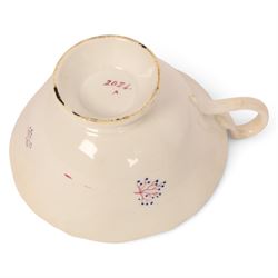 Late 19th century tea service, decorated with a green and pink strips, with internal decoration of budding branch within a gilt band upon a white glazed ground, comprising  twin handle lidded sucrier, milk jug, three serving plates, nine cups and saucers and four teacups