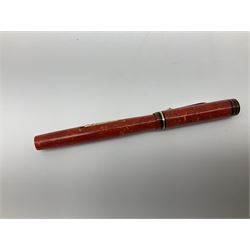 Vintage Swan Mabie Todd lever fill fountain pen in coral red, the nib a/f marked 14K, together with two further vintage Swan Mabie Todd fountain pens, the first example with lever fill, the other leverless, each with black body, one with nib marked 14ct, (3) 