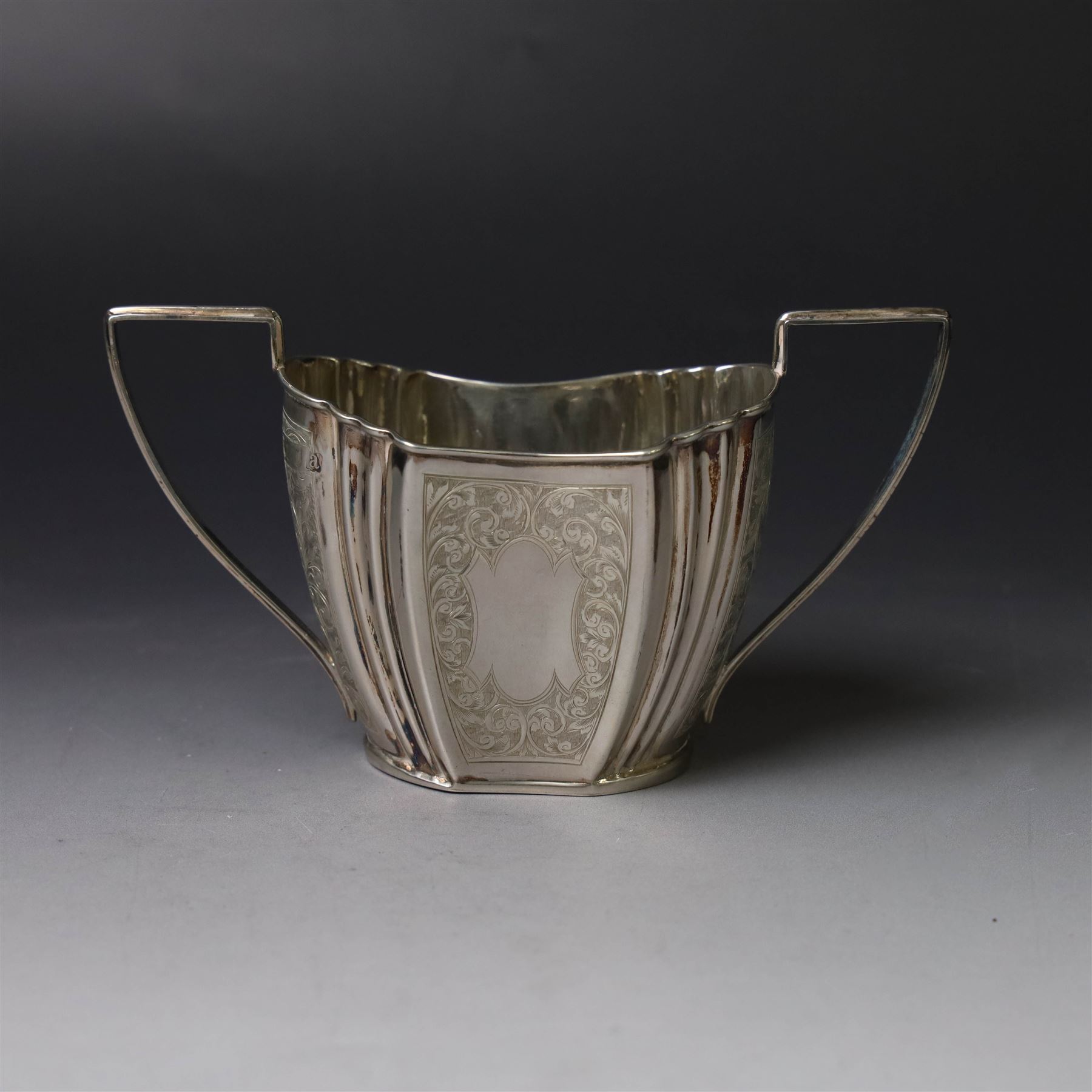 Late Victorian silver twin handled open sucrier and milk jug, of fluted form with panels of engraved foliate decoration, hallmarked D & M Davis, London 1896