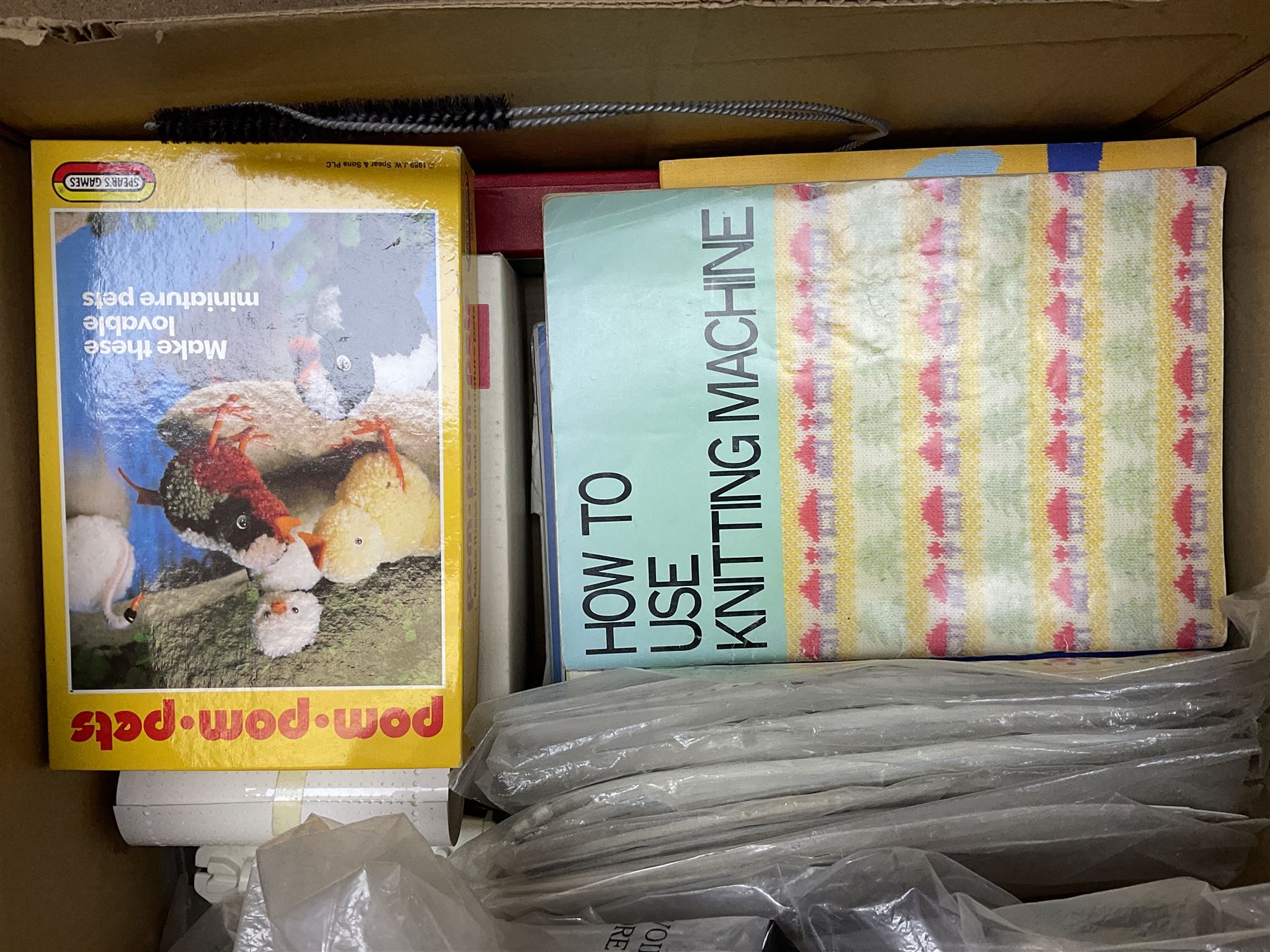  Brother cased knitting machine model KH-890 together with Brother Ribbing attachment model KH-850, knitting machine yarn cones in assorted colours, selection of knitting patterns etc