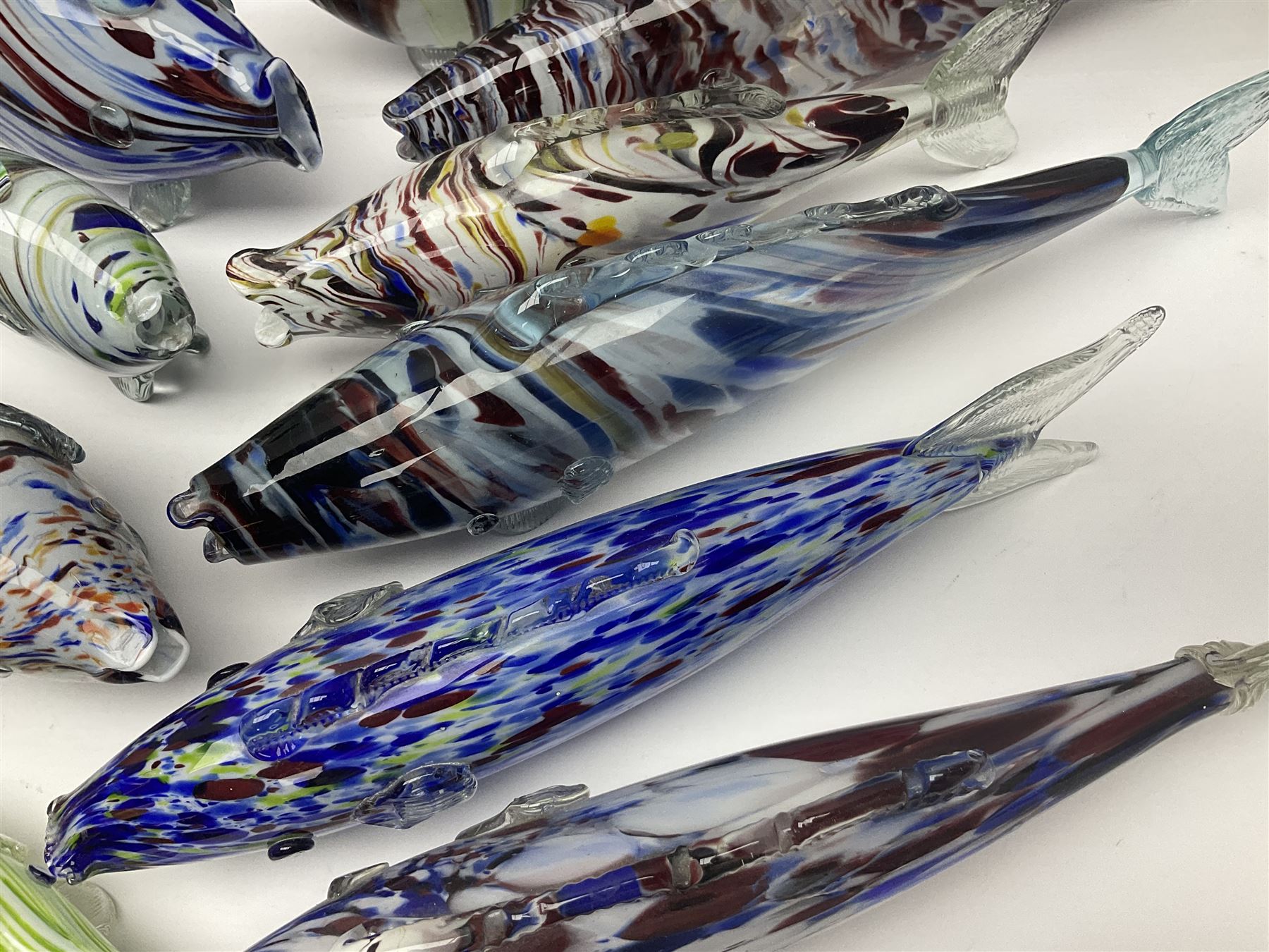 Collection of mid 20th century murano style glass fish, each with multi coloured inclusions largest L42cm