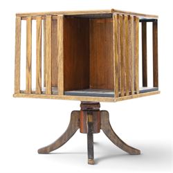 Early 20th century oak revolving bookcase, square top above four divided sections, raised on a revolving base