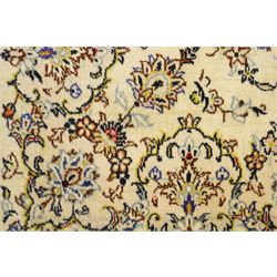 West Central Persian Sarough hand-knotted rug, ivory field with central lobed medallion issuing an all-over design of scrolling vines, palmettes, and floral sprays within conforming spandrels enclosed by a complementary foliate border flanked by guard stripes, with cotton fringe ends 